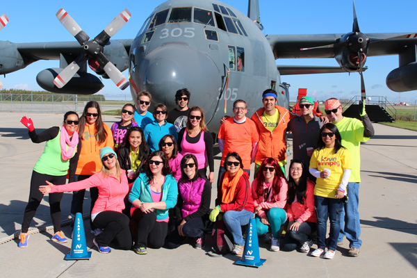 The CWB National Leasing team at the United Way Winnipeg Plane Pull event, decked out in their tight, florescent-coloured costumes..