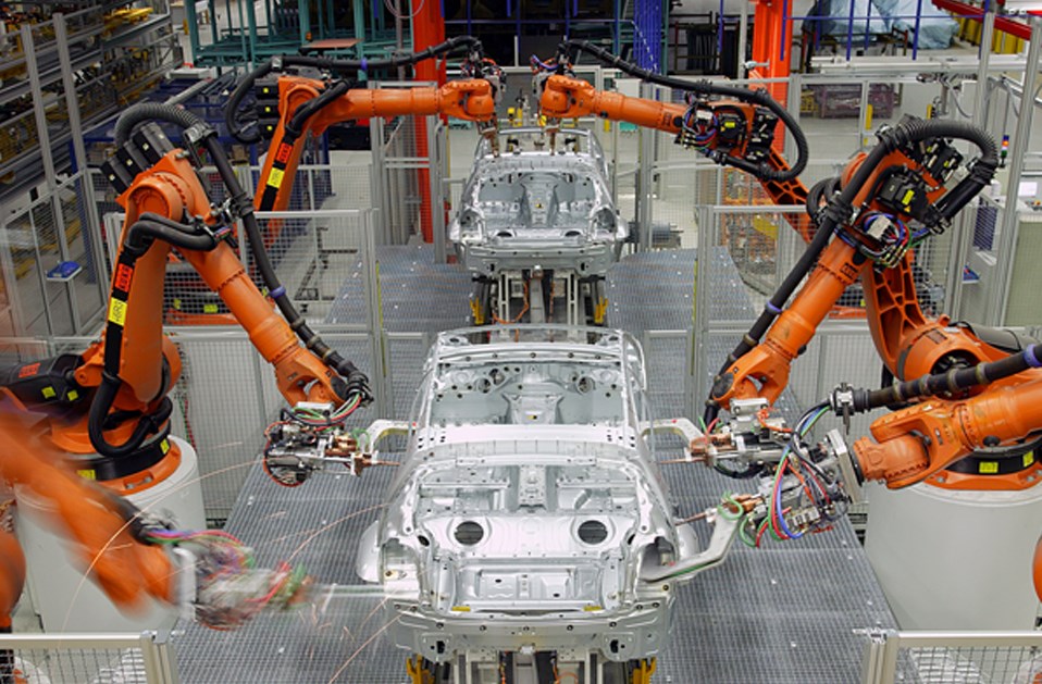 A photo of automated manufacturing equipment building cars