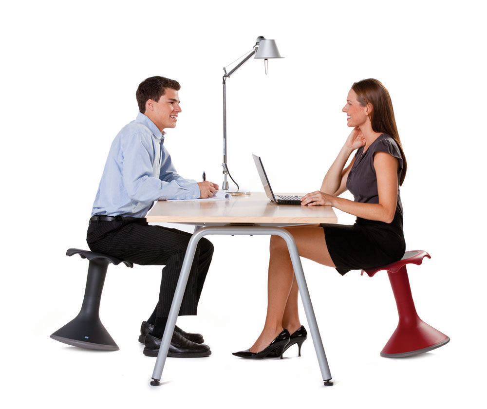 Two workers sitting on ergonomic Hokki stools