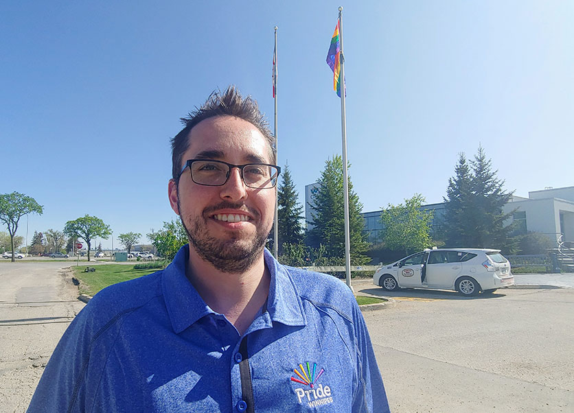 Barry Karlenzig by the Pride flag