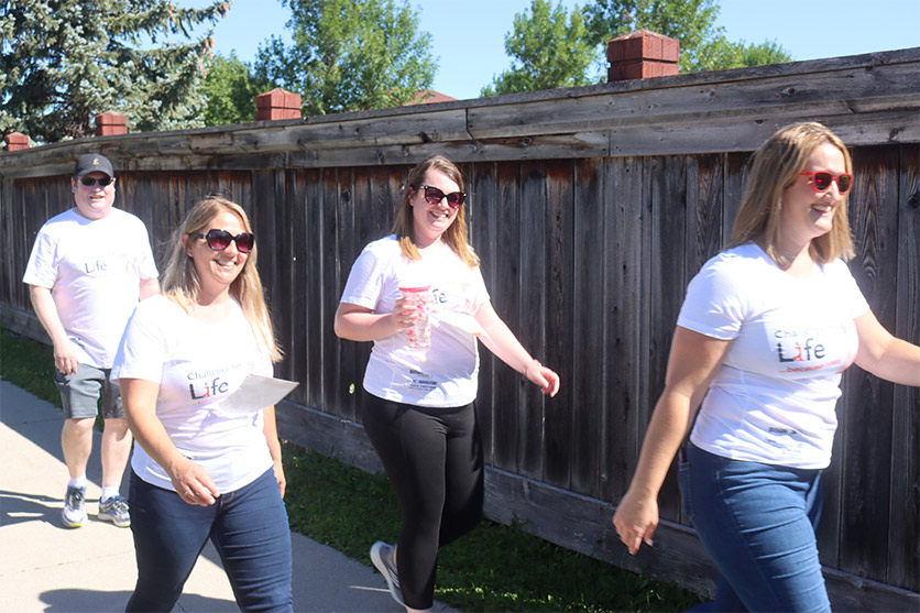 CWB National leasing team members in challenge for life merchandise walking by