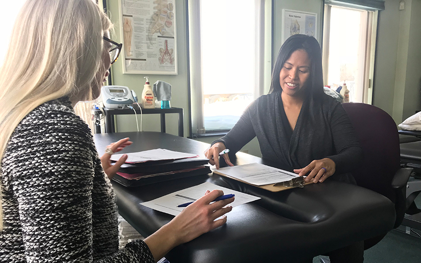 Raunora and Melanie signing docs