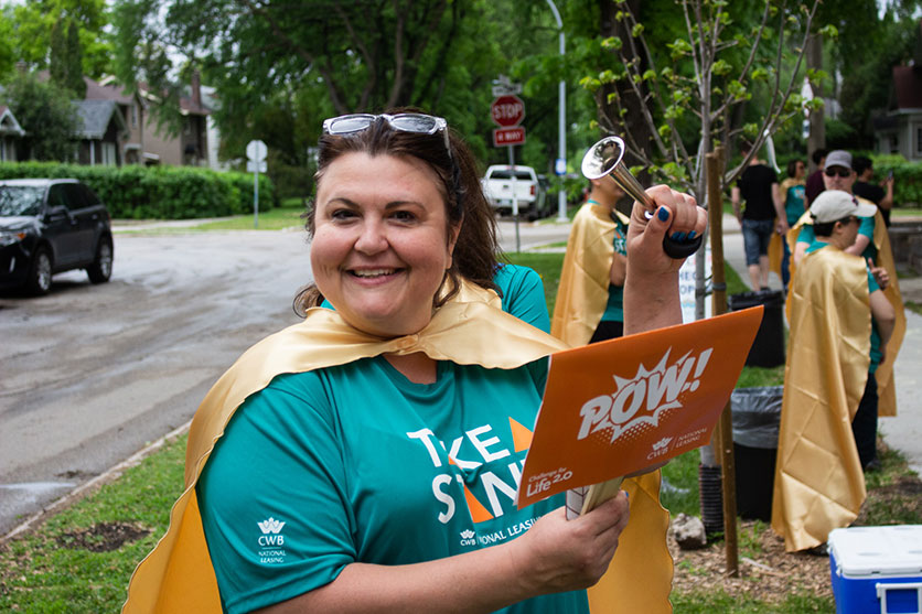 Photo of Caroline holding a Challenge For Life sign