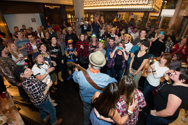 Fred Penner performs as CWB National Leasing employees crowd around