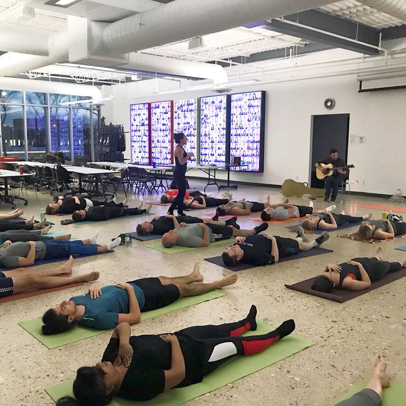CWB National Leasing employees enjoy a live music yoga class at head office with all the proceeds going toward United Way Winnipeg.