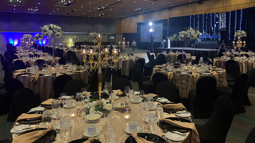 Tables and stage set up in the hall of the Winnipeg Gala venue. 