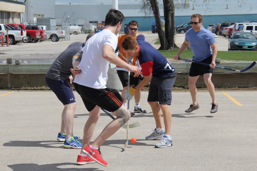 CWB National Leasing staff playing street hockey