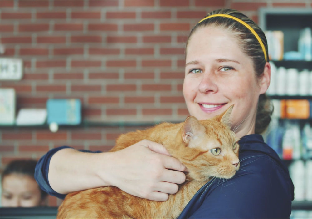 A proud pet owner holding her cat