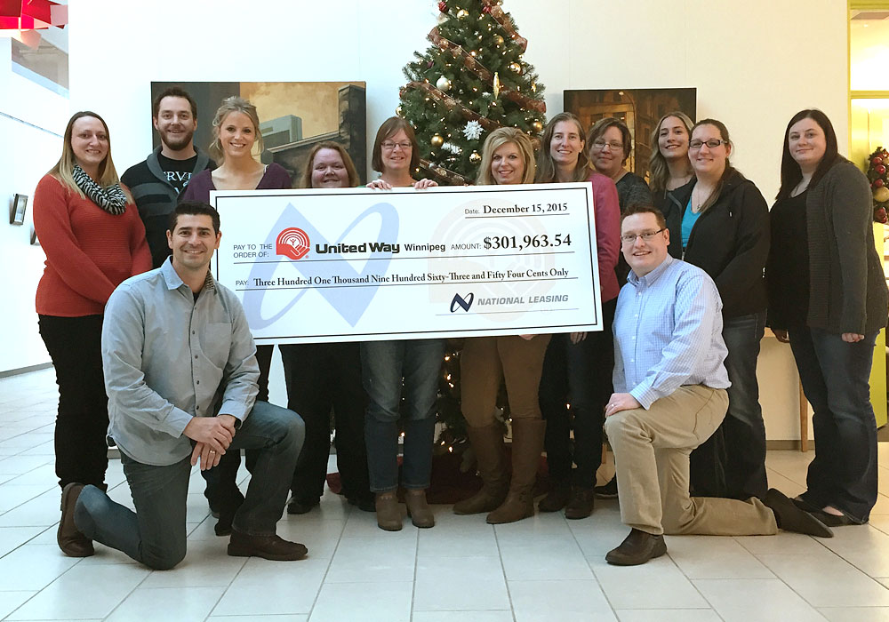 A photo of the Nationa Leasing United Way Committee with the oversized cheque they presented to United Way Winnipeg