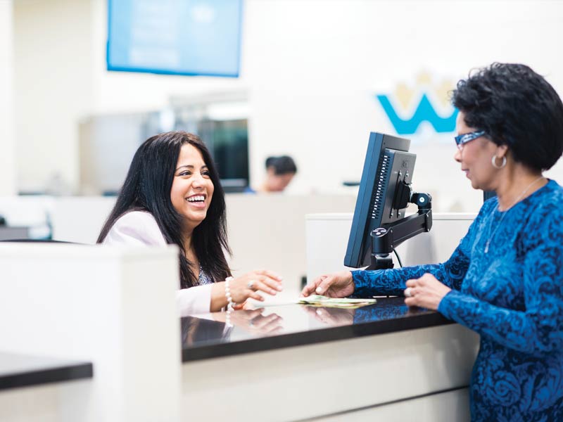 CWB employee smiling and helping a customer