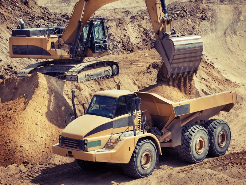 An excavator at work in the sand